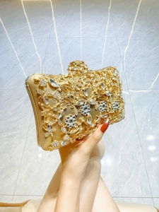 Elegant gold evening clutch bag with sparkling rhinestones and floral pearl decorations