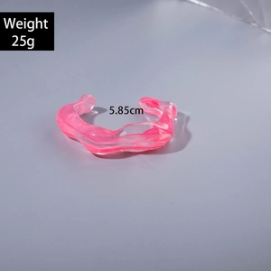 Detail of pink acrylic bangle showing irregular wave texture and 5.85cm inner diameter