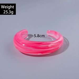 Detail view of pink textured acrylic cuff bracelet with 5.8cm inner diameter and 25.3g weight