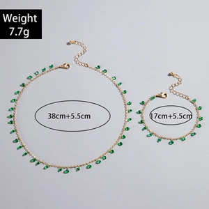 Detail of gold evil eye jewelry set featuring green teardrop beads and size markings