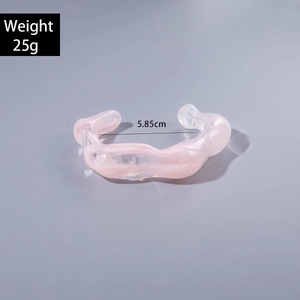 Detail of pink acrylic wavy bangle with clear texture showing 5.85cm inner diameter size