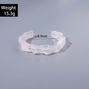 Detail of pink transparent acrylic cuff with 5.9cm inner diameter and rippled texture