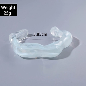Light blue wavy textured acrylic cuff bracelet showing 25g weight and 5.85cm inner diameter