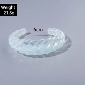 Macro shot of light blue acrylic cuff bracelet showing weight 21.8g and 6cm diameter