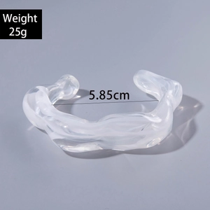 Detail view of irregular acrylic cuff with texture showing 5.85cm inner diameter and 25g weight