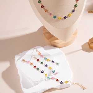 Detailed set of gold star jewelry with vibrant multi-color enamel charms on a display stand