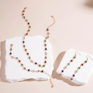 Detailed set of heart-shaped colorful crystal necklace, bracelet and earrings set in gold