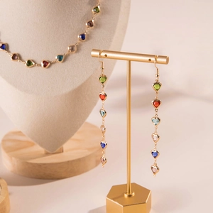 Detail of colorful heart-shaped crystal necklace and earrings set on a display stand