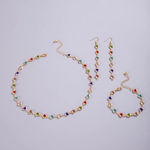 Detailed view of gold necklace set with colorful heart-shaped gems and lobster clasp