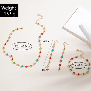 Detailed view of colorful Bohemian tassel necklace set with faceted gems and gold finish