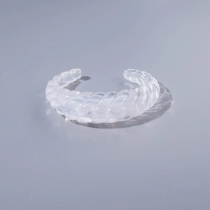 Transparent acrylic open bangle featuring geometric spiral textures and a modern look