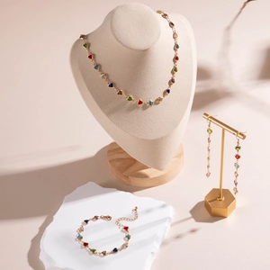 Three-piece gold jewelry set with colorful heart stones including necklace and earrings