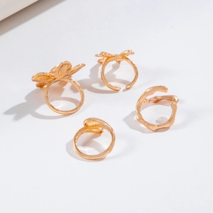 Set of four gold floral and bow adjustable rings with minimalist irregular open designs