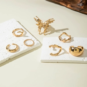 6-piece gold ring set featuring large butterfly and irregular lava flow metal designs