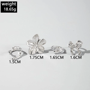 Detailed view of silver flower rings and bow jewelry set with 1.5-1.75cm dimensions