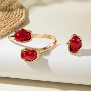 Detail of Baroque style gold bracelet and ring set with irregular red pearls