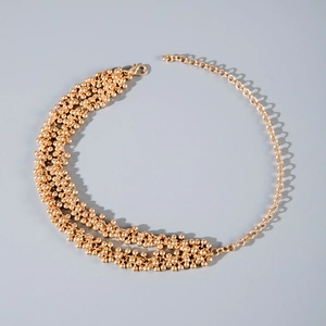 Detail of multi-layered golden CCB bead necklace showing lobster clasp and chain