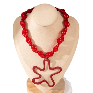 Statement red chunky beaded necklace with a large hollow flower pendant on a neck display