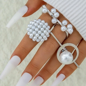 Three-piece silver alloy pearl ring set with geometric hollow designs on a hand
