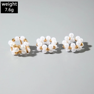 Detailed view of a 3-piece set of faux pearl and gold geometric bead rings weighing 7.6g