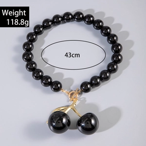 Detail showing oversized black acrylic bead necklace with gold cherry pendant 43cm 118.8g