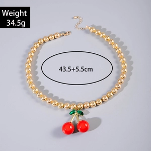 Detail view of cherry pendant necklace with gold beads showing 34.5g weight and 43.5cm length