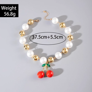 Detail of beaded necklace with white pearls, red cherry pendant, and size specifications