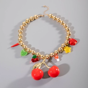 Detailed close-up of chunky gold bead necklace featuring red cherry and mixed charms