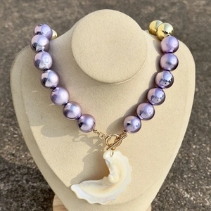 Fashionable oversized purple acrylic bead necklace with a white shell pendant and gold OT buckle
