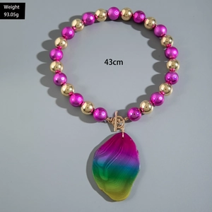 Detail of 43cm beaded necklace with purple and gold beads and rainbow agate pendant