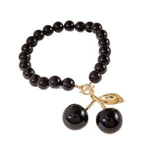 Fashionable black beaded necklace with a metallic gold cherry pendant and OT toggle clasp