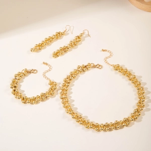 Macro view of vintage gold CCB beaded jewelry set featuring necklace, bracelet and earrings