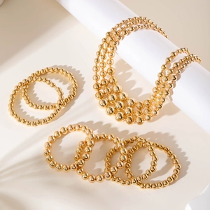 Three-layer gold beaded layered necklace and matching bracelet set in polished finish
