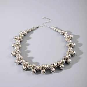 Detail of chunky silver beaded choker necklace featuring high-polish finish and lobster clasp