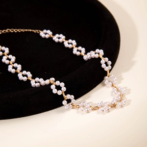 Fashionable faux pearl choker necklace with floral clusters and adjustable gold chain