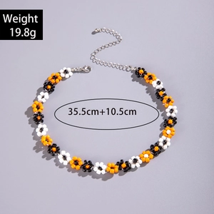 Detail view of colorful beaded daisy necklace with lobster clasp and extension chain