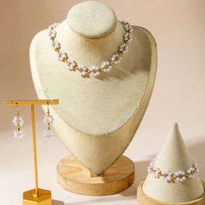 Detail view of pearl floral jewelry set with necklace, earrings and bracelet on display