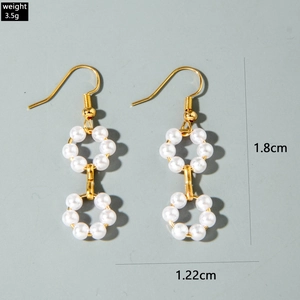 Close-up of gold pearl drop earrings showing 1.8cm height and 3.5g weight details