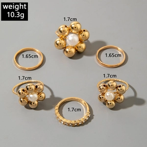 Detailed view of 6pcs gold alloy ring set with white pearls and sparkling pavé crystals