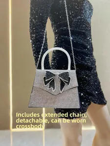 Detail of rhinestone trapezoid handbag with black crystal bow and detachable silver chain