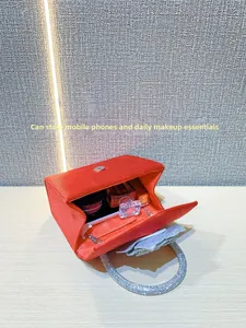 Top view of red velvet evening bag interior showing space for phone and makeup essentials