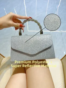 Detail of silver sequin evening bag with a crystal spiral handle and reflective polyester