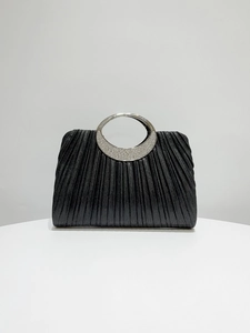 Close-up of pleated black leather evening bag with rhinestone-encrusted silver ring handle