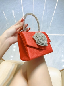Luxury red satin evening handbag with a large silver rhinestone rose and sparkling handle
