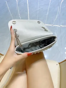 Detail view of the spacious silver pearl evening clutch with a secure chain strap