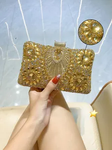 Detail of evening clutch with gold rhinestones in floral clusters and metal top clasp