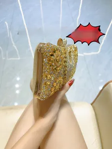 Close-up of gold dinner clutch featuring intricate floral rhinestone pattern and ring clasp