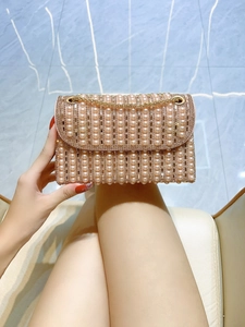 Close-up of pink pearls and rhinestones on the elegant evening clutch bag detail