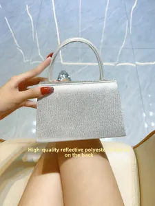 Detail of high-quality reflective silver polyester material on a rhinestone evening clutch