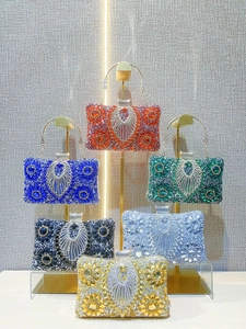 Luxurious evening clutch bags with radiant rhinestones in emerald, gold, and blue colors